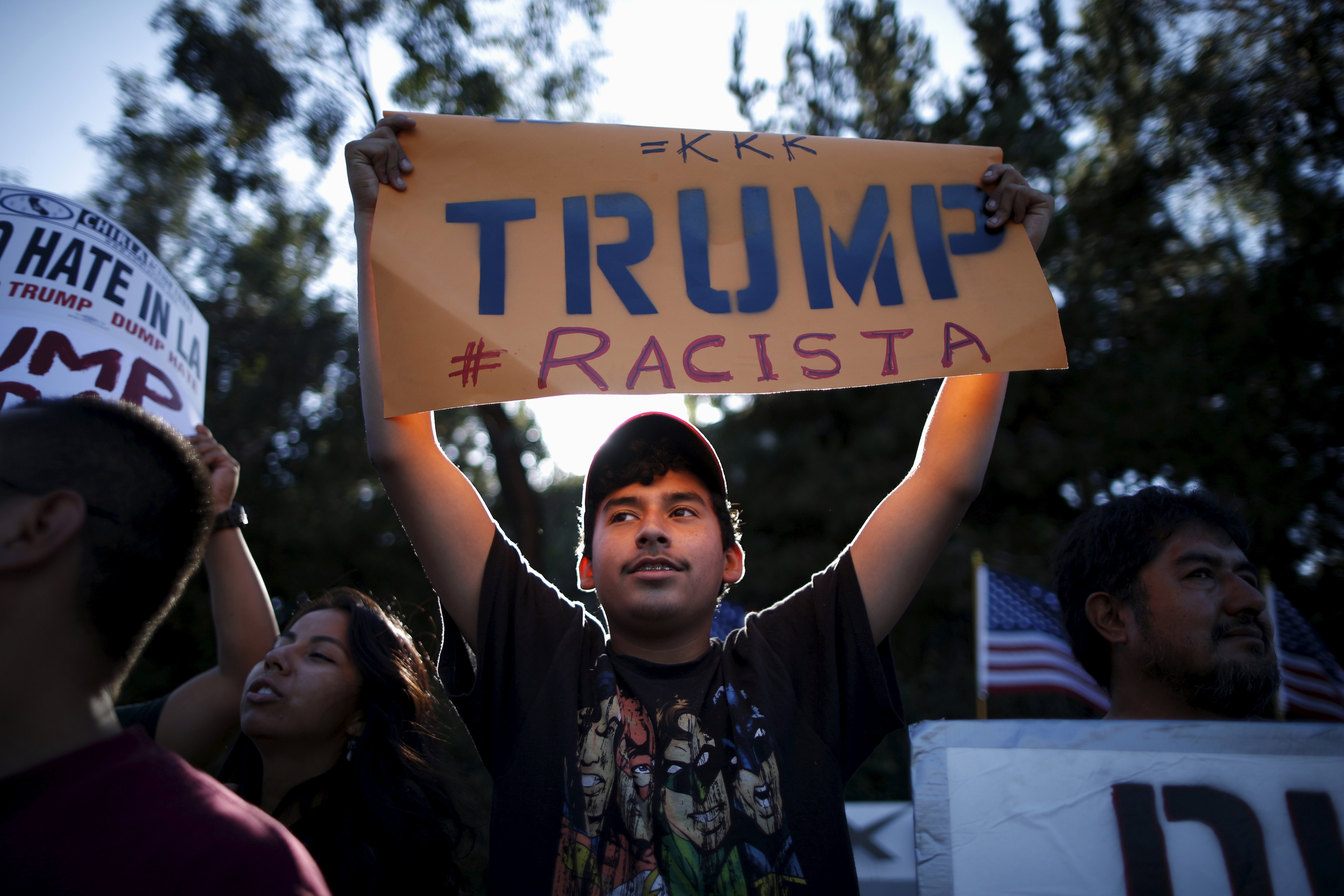 People protest outside the Luxe Hotel, where Republican presidential candidate Donald Trump was expected to speak in Brentwood, Los Angeles, California, United States July 10, 2015. At least 10 businesses have severed deals with billionaire presidential contender Donald Trump after his disparaging comments about Mexican immigrants, following vigorous lobbying by Latinos and others. Trump said that some of his criticism has been distorted. REUTERS/Lucy Nicholson TPX IMAGES OF THE DAY - RTX1JYH8