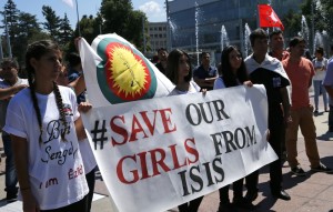 (Photo: Reuters/Denis Balibouse) Women hold a banner during a demonstration marking the first anniversary of Islamic State's surge on Yazidis of the town of Sinjar, in front of the United Nations European headquarters in Geneva, Switzerland, August 3, 2015. 