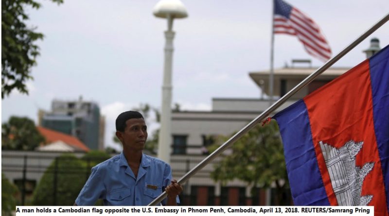 A man holds a Cambodian flag opposite the U.S. Embassy in Phnom Penh, Cambodia, April 13, 2018. REUTERS/Samrang Pring